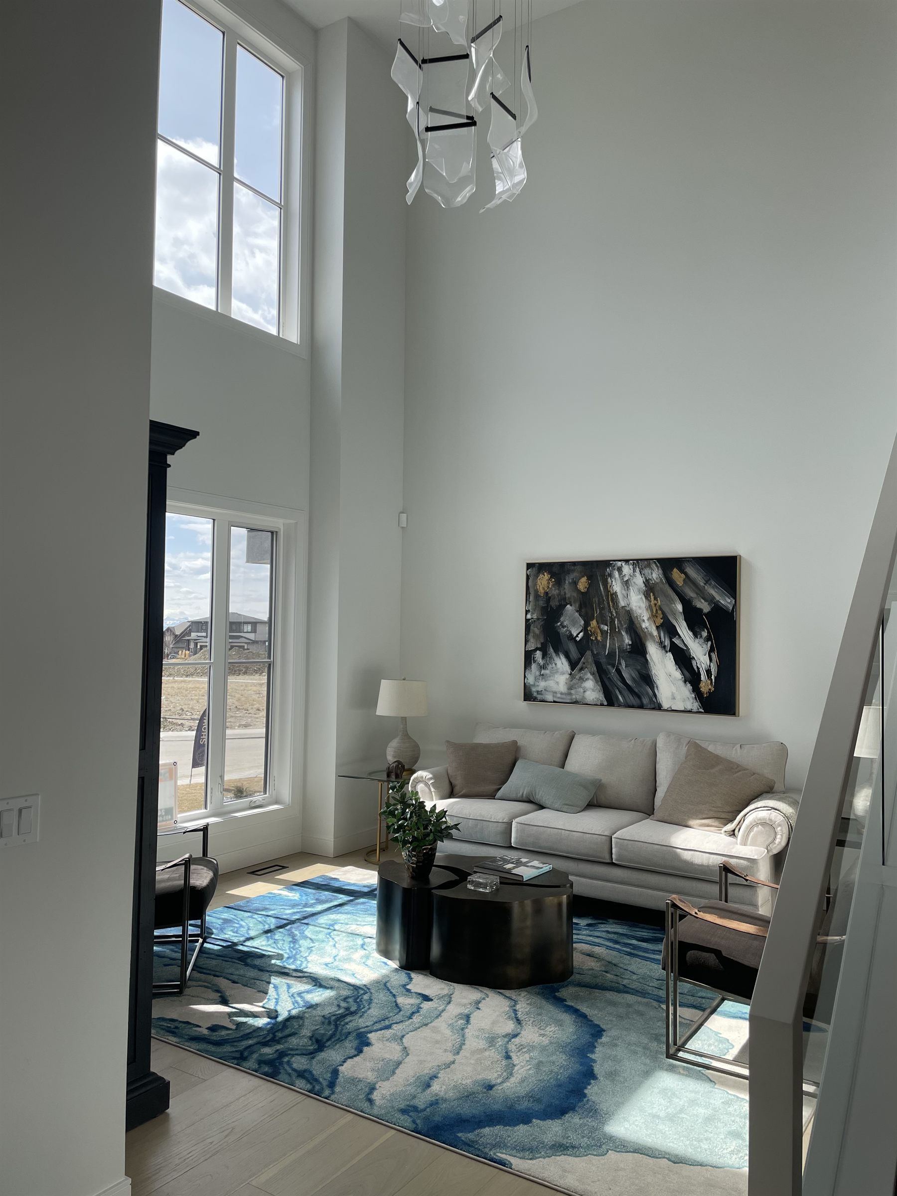 Living room with statement art and a blue rug